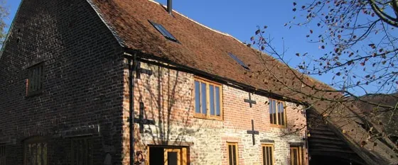 A converted brick barn with oak windows and doors